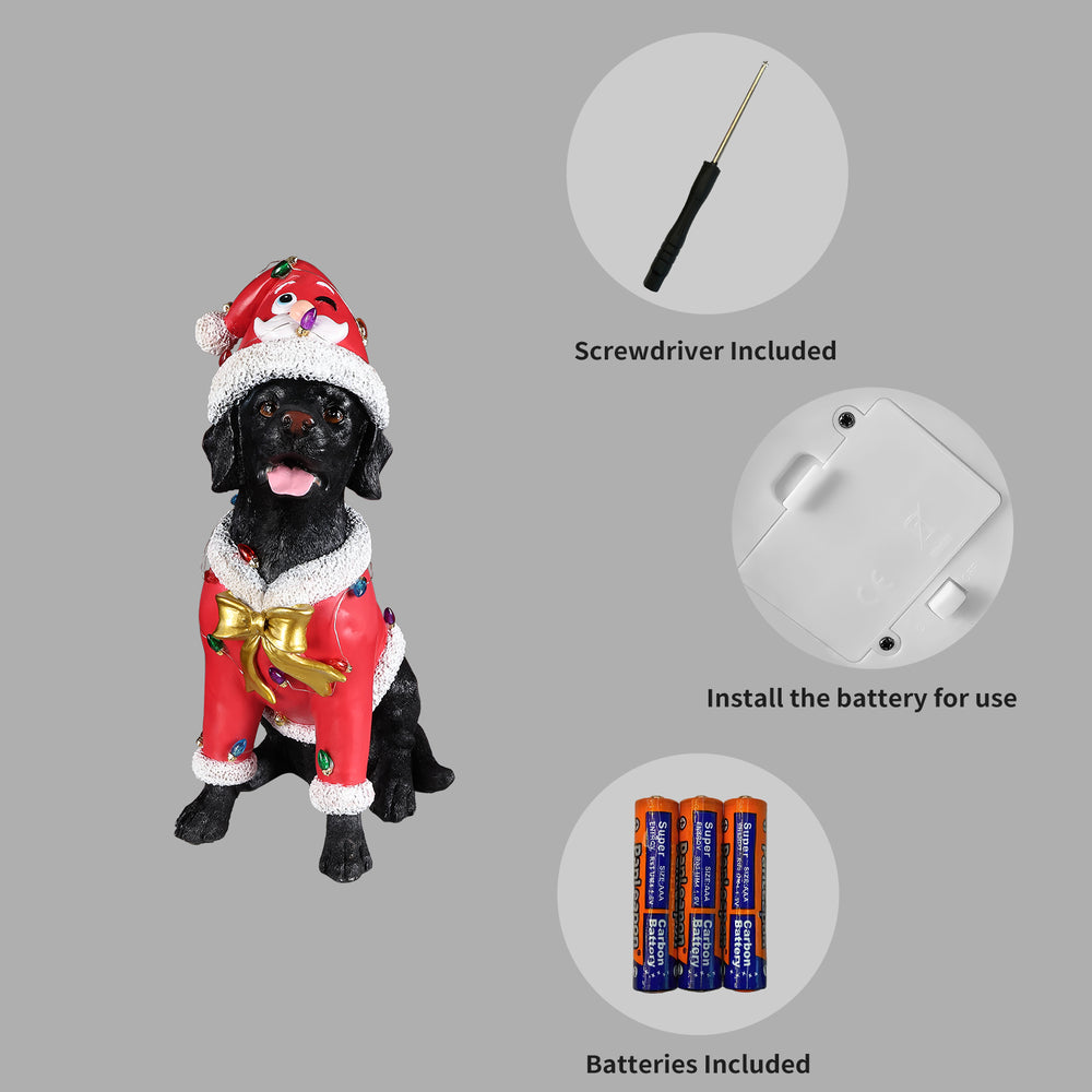 Panel showing what is included with the Black labrador retriever statue: the batteries, the small screwdriver and the cover plate on the underside of the base