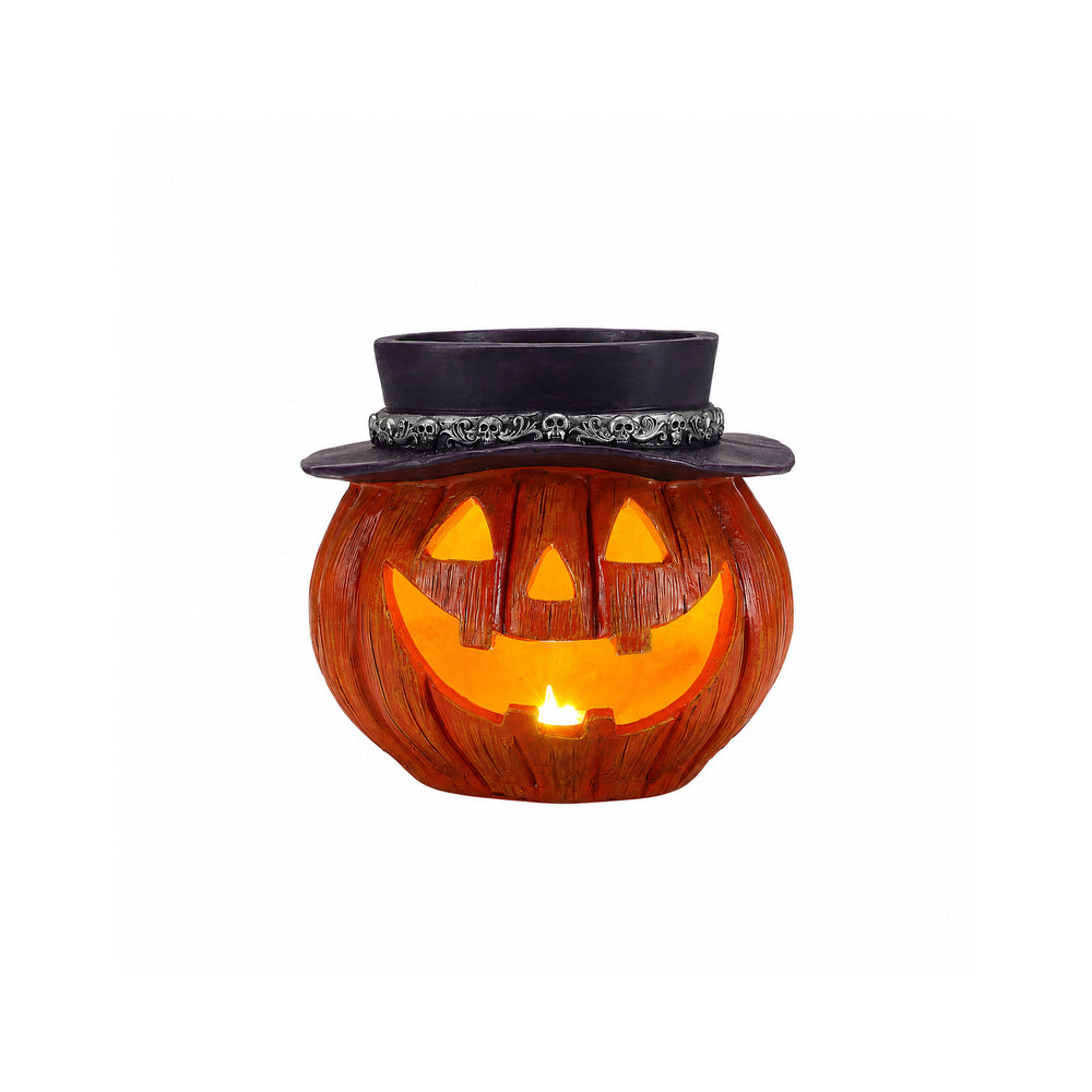 Halloween pumpkin candy bowl on a plain background, front view, showing the carved triangular face glowing