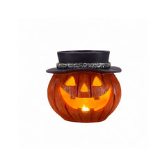 Halloween pumpkin candy bowl on a plain background, front view, showing the carved triangular face glowing
