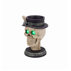 Feather hat skull candle holder on a plain background, front view, with a rose and feather accent on the hat band