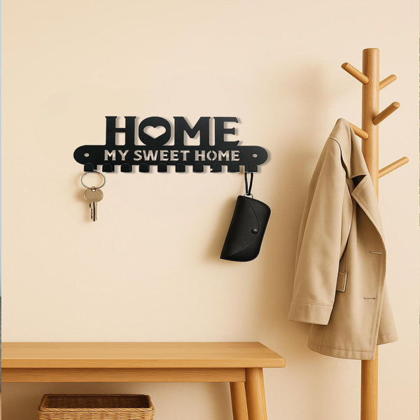 Wall hook rack holding a red snowflake towel and a gingerbread ornament in a kitchen
