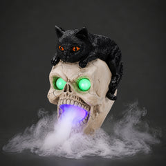 Black cat skull light up decor on a dark background, three quarter view, showing the cat resting on the crown of the skull