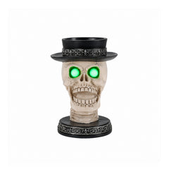 Gothic skull candle holder on a plain background, front view, with an open laughing jaw and a silver banded top hat