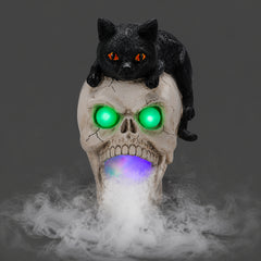 Black cat skull Halloween statue on a dark background, front view, with fog leaving the mouth