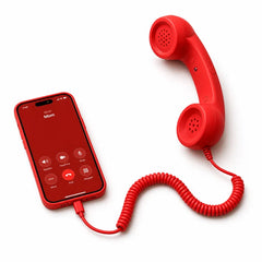 Retro smartphone handset in red resting on a desk, close view of the earpiece and mouthpiece