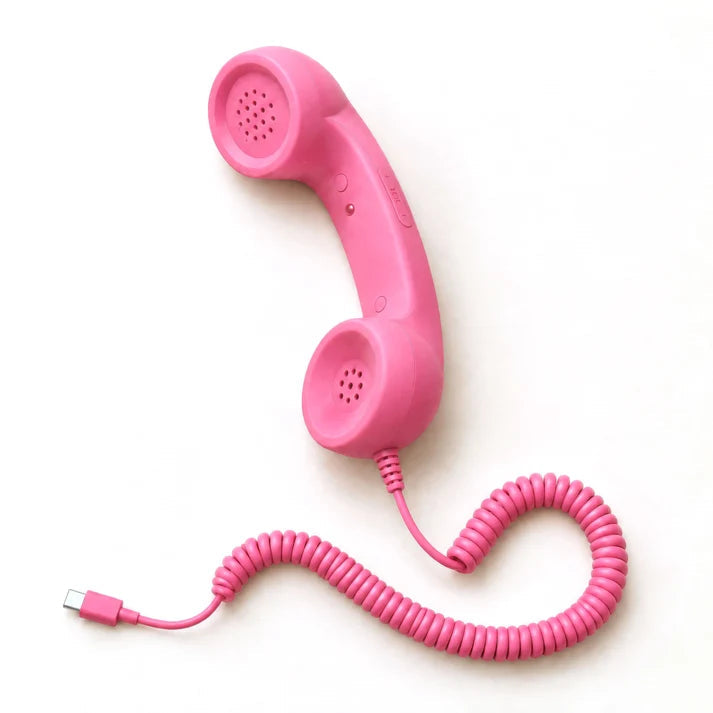 Retro smartphone handset, pink, with the USB-C plug