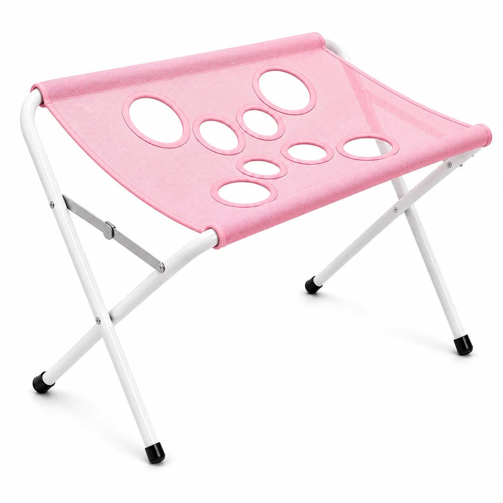 Foldable pet bath and grooming stand, pink surface with leg openings on a folding frame