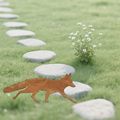 Walking fox metal yard stake set among paving stones in a lawn