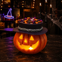 The same light up pumpkin treat bowl from a second angle with the black witch hat rim around the opening