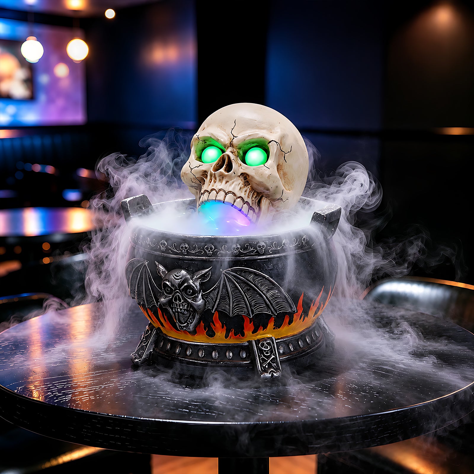 The same skull cauldron decor from a second angle with the mist maker running and the mouth lit purple