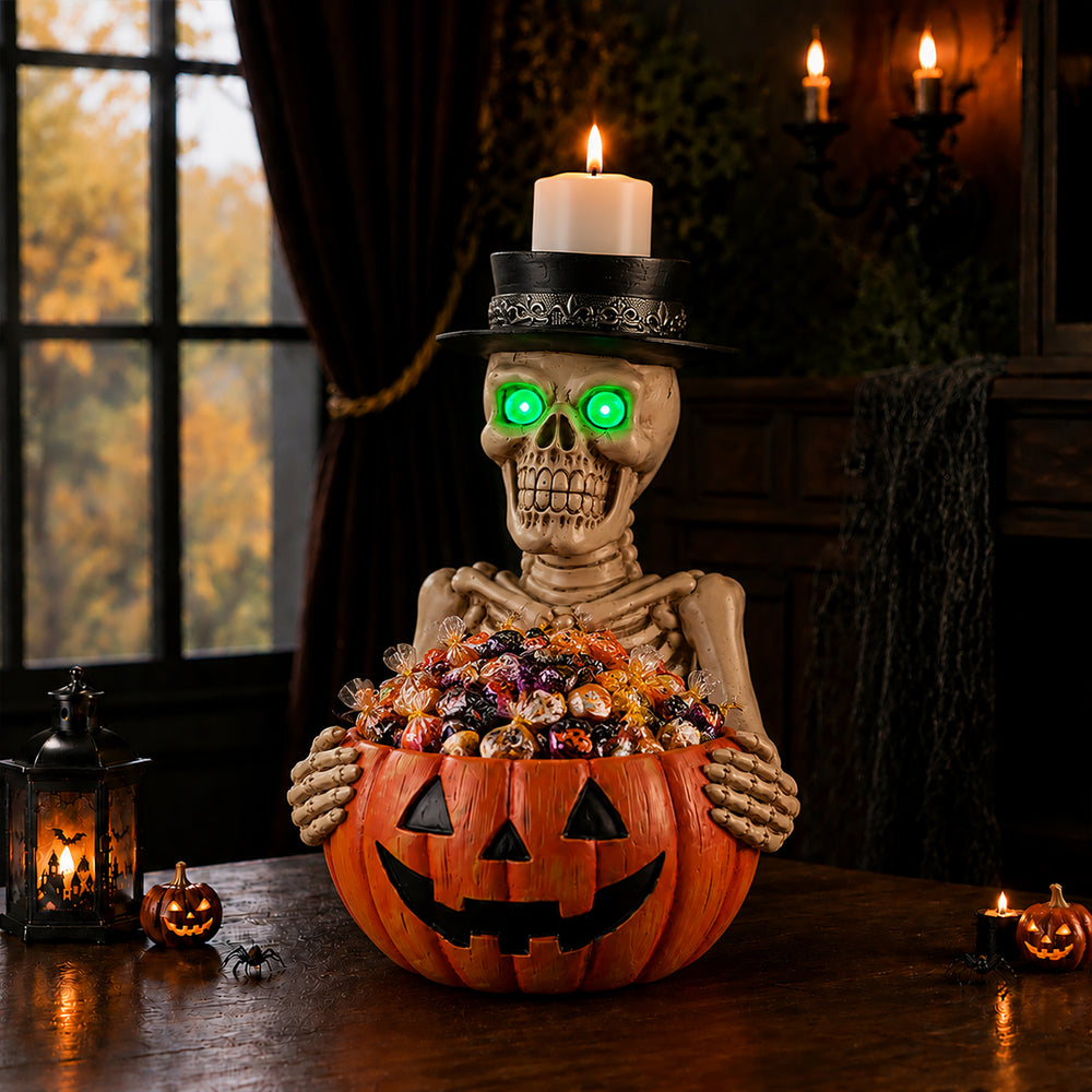 The same skeleton candy bowl centerpiece from a second angle on a dark bar counter with glasses behind it