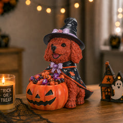 The same brown poodle witch puppy beside a lit candle and a small haunted house on a shelf