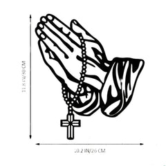 Praying hands with rosary metal art above a mantel with picture frames