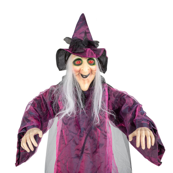 Hanging witch prop reaching out with molded hands on a staircase