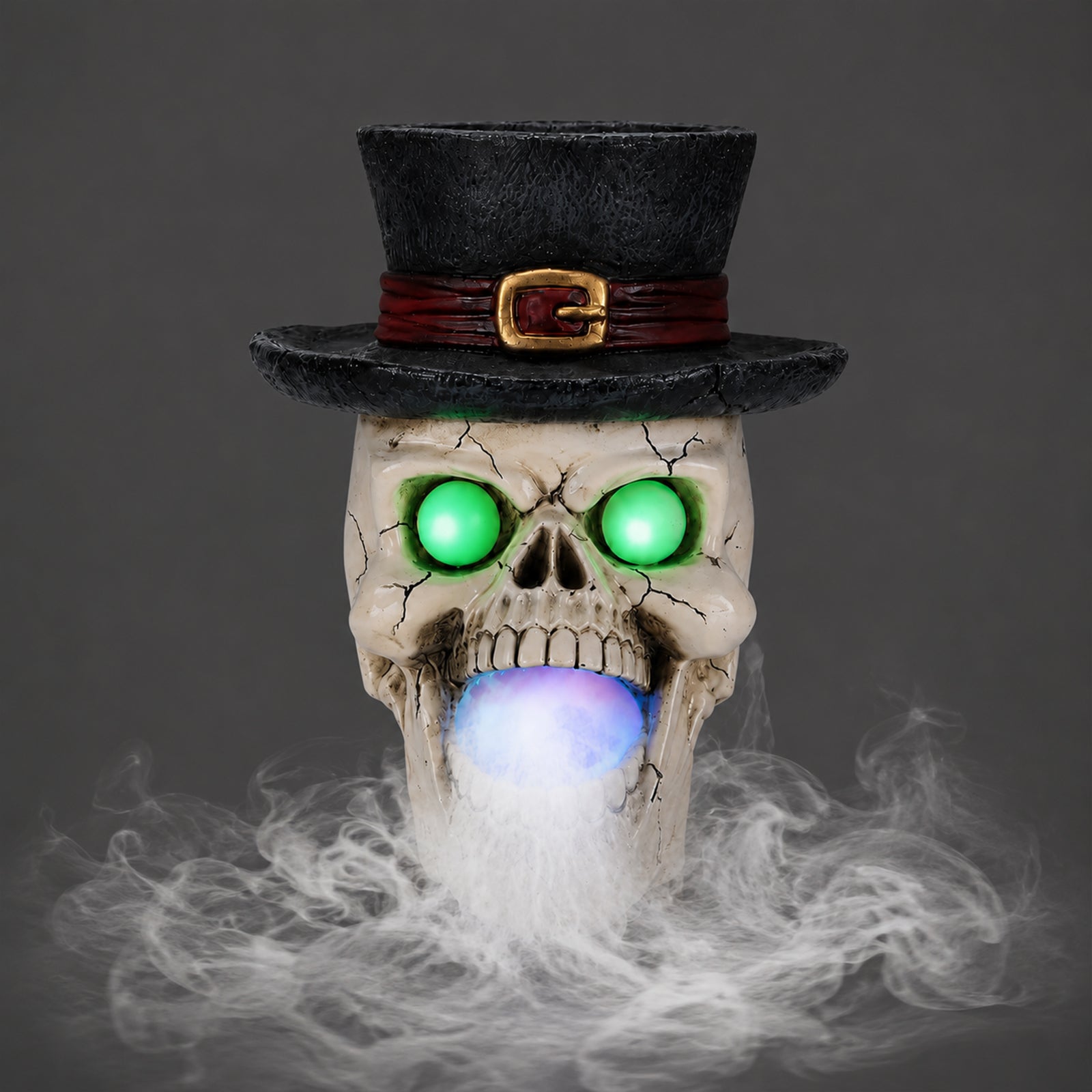 Top hat skull resin figure on a plain gray background, side view, with the mist maker unit below