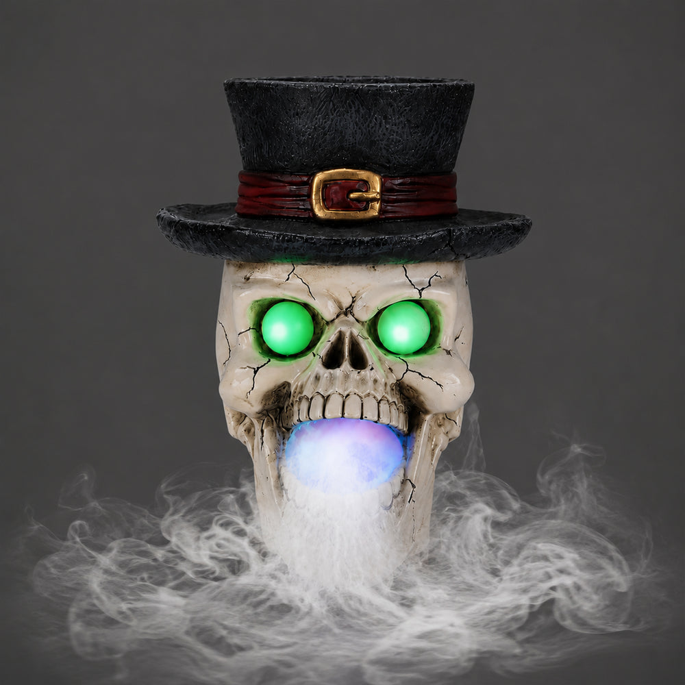Top hat skull resin figure on a plain gray background, side view, with the mist maker unit below