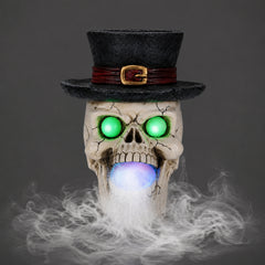 Top hat skull resin figure on a plain gray background, side view, with the mist maker unit below