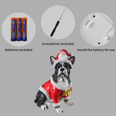 Panel showing what is included with the French bulldog statue: the batteries, the small screwdriver and the cover plate on the underside of the base