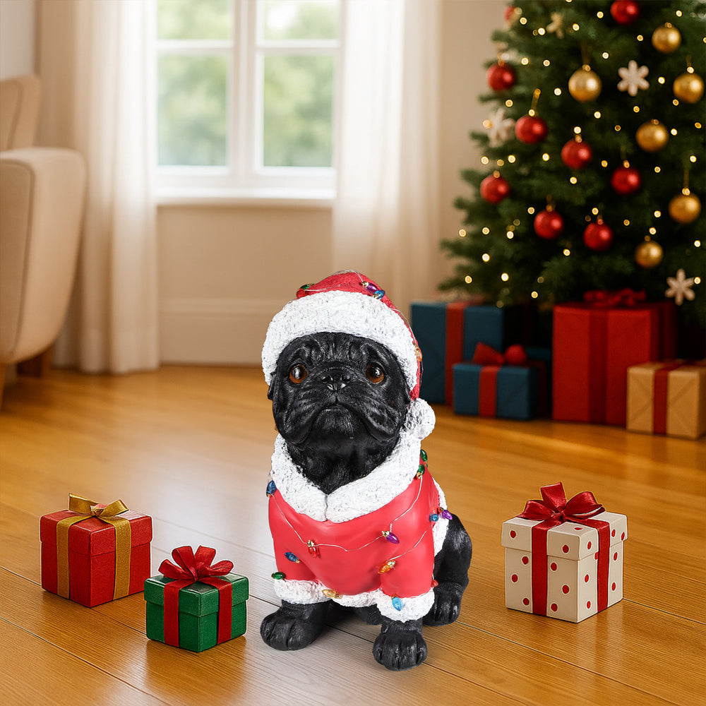 The Pug in the red Santa coat by a window with snow on the garden outside