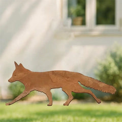 Rusted metal fox silhouette garden stake standing in grass by a path