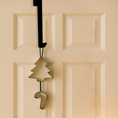 Black over door iron hanger holding two knitted stockings on a white door