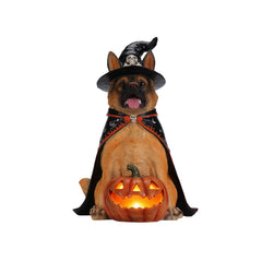 German shepherd witch statue on a plain background, front view, with a skull ornament on the hat band