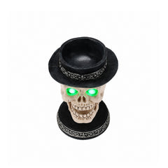 Skull candle holder light up decor on a plain background, side view, with the hat lifted off to show the hollow top of the skull
