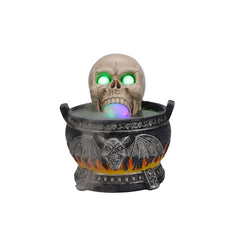 Skull cauldron Halloween statue on a plain background, front view, showing the bat wing and flame relief on the cauldron