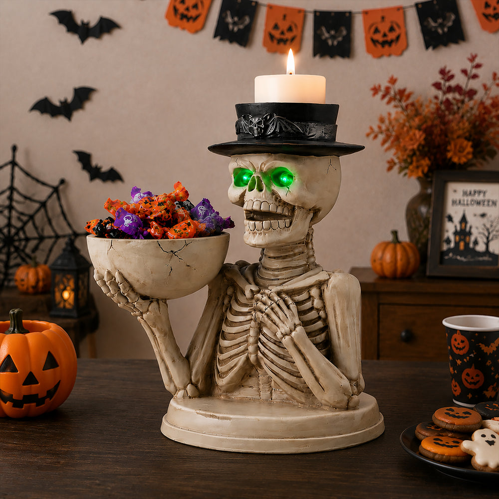 The same skeleton server statue on a sideboard with a carved pumpkin and purple light behind it