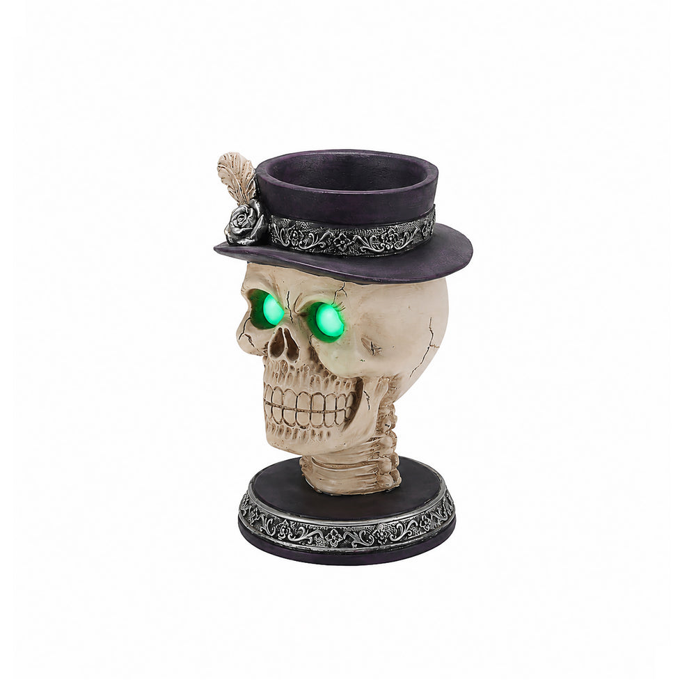 Feather hat skull candle holder on a plain background, front view, with a rose and feather accent on the hat band