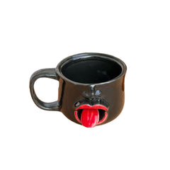 Weirdly shaped cup with a tongue sticking out - ceramic mug. A funny and amusing gift for pranks.