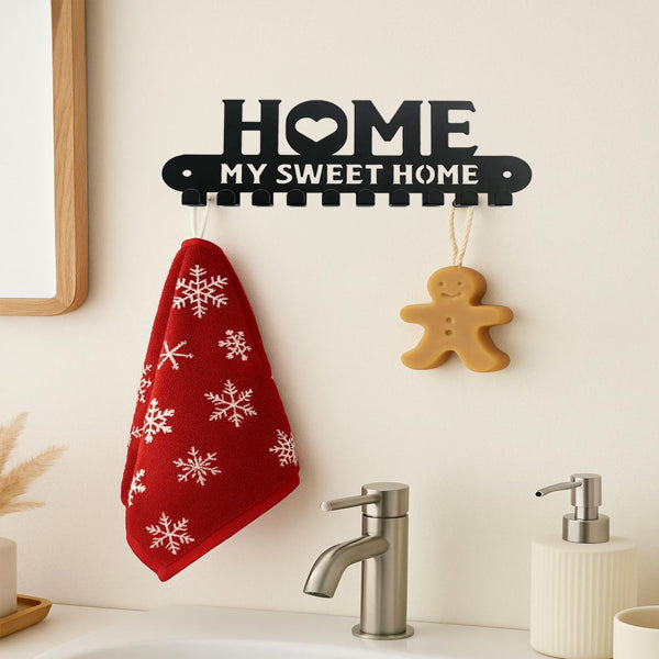 Metal wall hanging rack with hooks in a plant corner holding a watering can