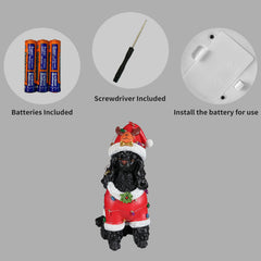 Panel showing what is included with the Black poodle statue: the batteries, the small screwdriver and the cover plate on the underside of the base