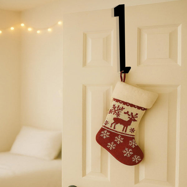 Over door hanger holding a stocking filled with books beside a desk