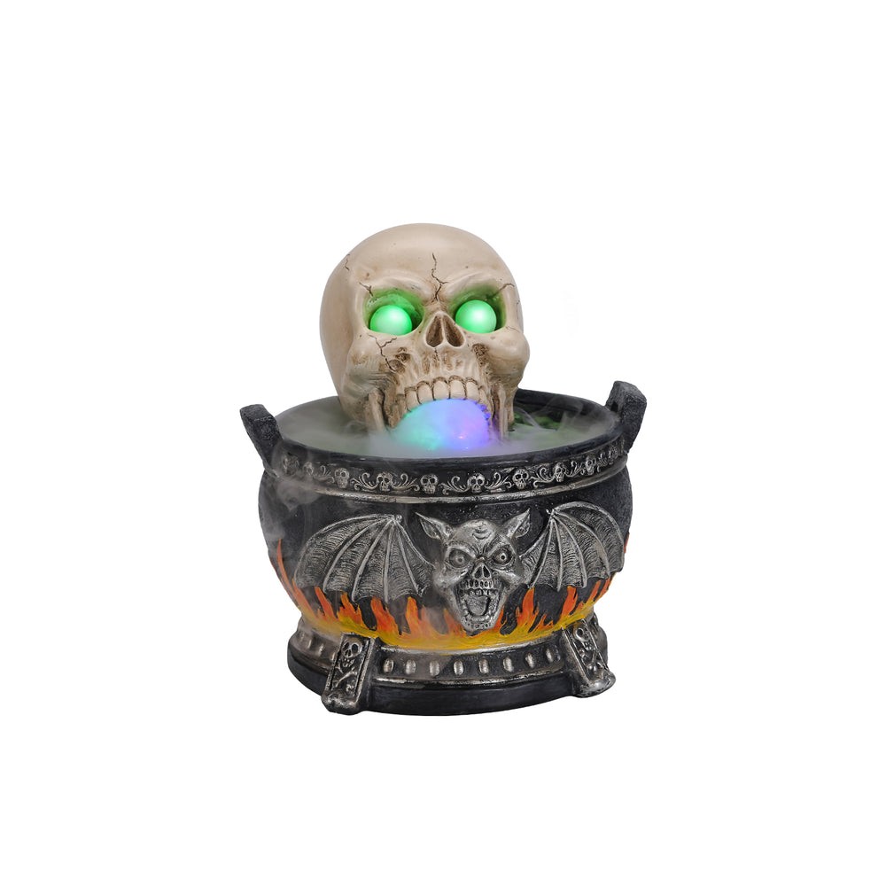Skull cauldron light up decor on a plain background, turned three quarters to show the cracked skull leaning over the rim