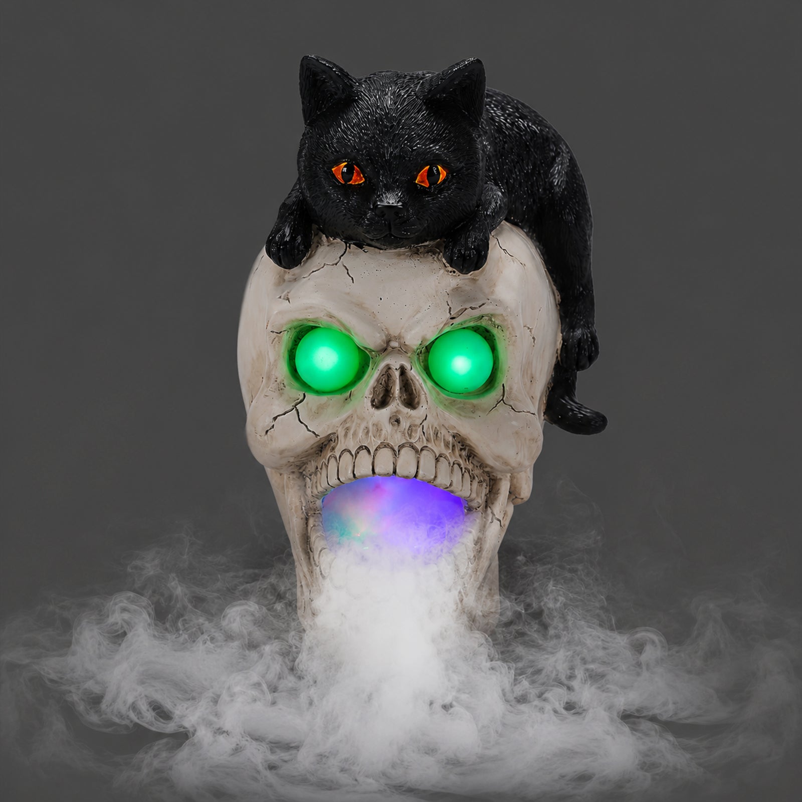 Black cat skull Halloween statue on a dark background, front view, with fog leaving the mouth