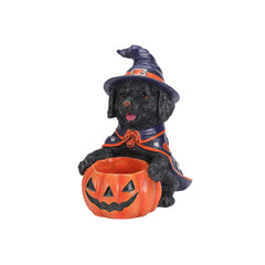 Black labrador witch puppy statue on a plain background, front view, with the bowl full of candy
