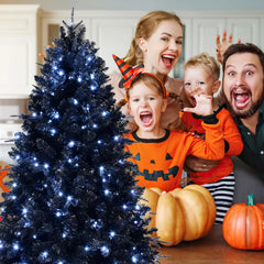 Tall black pre lit tree with white LED lights against a bright window