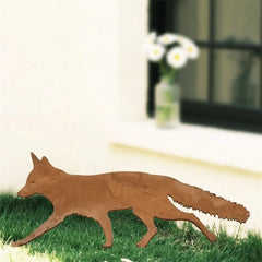 Fox silhouette stake set on top of a clipped hedge beside a doorway