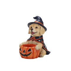 Labrador witch puppy statue on a plain background, front view, holding the jack o lantern bowl of treats