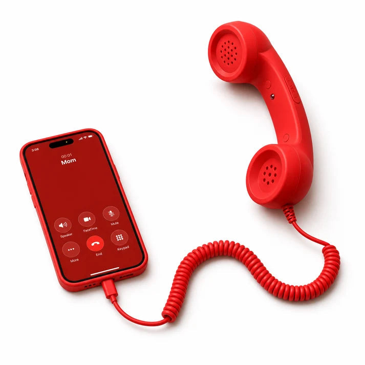 Retro smartphone handset in red resting on a desk, close view of the earpiece and mouthpiece