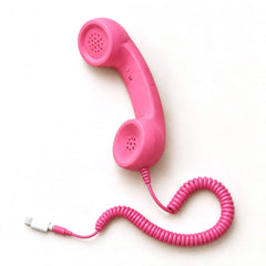 Retro smartphone handset, pink, with the Lightning adapter plug