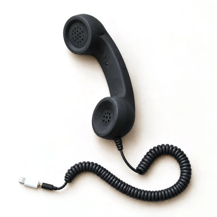 Retro smartphone handset, black, with the Lightning adapter plug