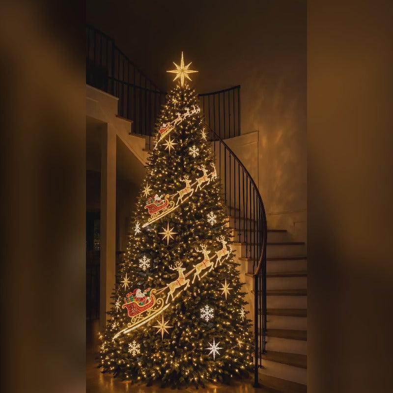 The sleigh design on a warm white lit Christmas tree: reindeer and sleds running down the front of the tree beside a staircase
