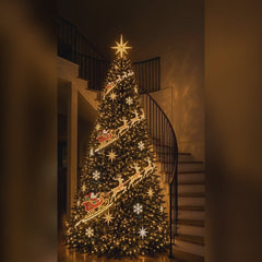 The sleigh design on a warm white lit Christmas tree: reindeer and sleds running down the front of the tree beside a staircase