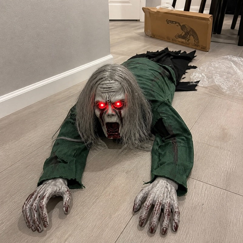 The long hair version of the crawling zombie prop on the floor beside its open box